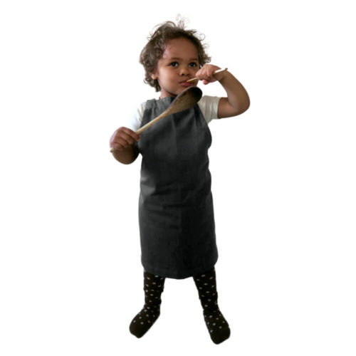 Kids apron, age 3-6 in durable organic cotton. Bringing generations together through the joy of baking, cooking or getting messy with crafts. A simple design with a neck and waist strap. 45 X 55 cm. Seen here in dark grey. For older young chefs, we have the Junior Apron, for (around) 7-11 year olds.